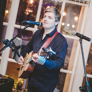 musician Todd Nathaniel playing guitar at wedding